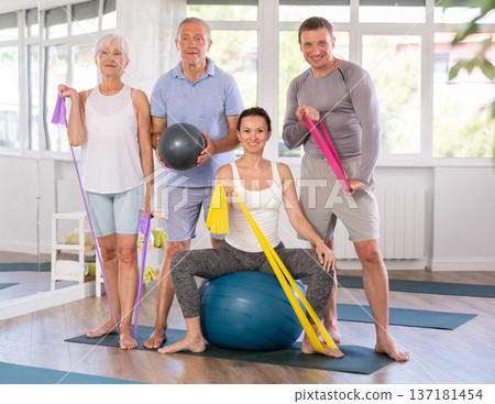 Coach and elderly visitors of fitness course smile happily after training 137181454