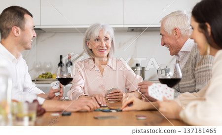 Senior woman playing poker with husband and adult children Senior woman playing poker with husband and adult children 137181465