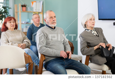 Mature people are listening to lecture in auditorium. Group psychological interaction, practical classes in psychology Mature people are listening to lecture in auditorium. Group psychological interaction, practical classes in psychology 137181502