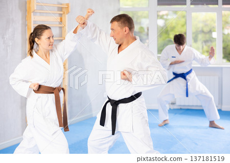 Man and woman train to perform basic defensive attacking actions during mortal techniques classes 137181519