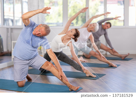 Elderly man doing pilates in group 137181529