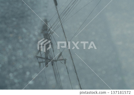 Towering electric poles in the rain 137181572
