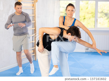 Guy paired up with woman to perform effective impact on pain points while learning self-defense. Guy paired up with woman to perform effective impact on pain points while learning self-defense. 137181602