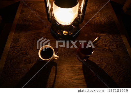 A quiet moment in the evening with lantern light and coffee A quiet moment in the evening with lantern light and coffee 137181929