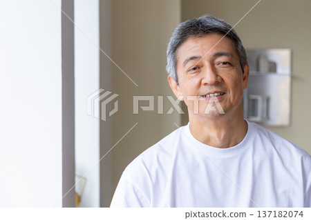 Senior men standing at the windowside Senior men standing at the windowside 137182074