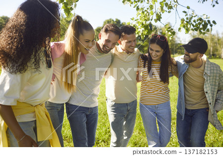 Happy friends standing closely embracing in sunny summer green park, diverse friendly group smiling 137182153