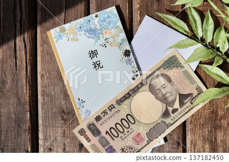 A light blue floral gift envelope and a new 10,000 yen bill A light blue floral gift envelope and a new 10,000 yen bill 137182450
