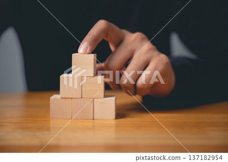 A powerful sign of growth, this closeup shows a man hand pose in a gesture to build a pyramid, a clear business sign of strategic planning and future achievement 137182954
