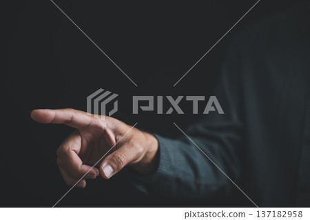 Close-up of a hand reaching out against a black background, with fingers extended. Close-up of a hand reaching out against a black background, with fingers extended. 137182958