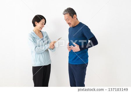 A man concerned about obesity and his trainer A man concerned about obesity and his trainer 137183149