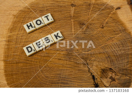 Scrabble letters spell hot desk on wooden surface for National Scrabble Day Scrabble letters spell hot desk on wooden surface for National Scrabble Day 137183168