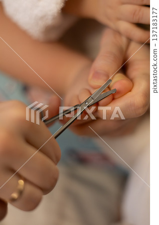 Cutting nails during a baby grooming session at home in the afternoon Cutting nails during a baby grooming session at home in the afternoon 137183177