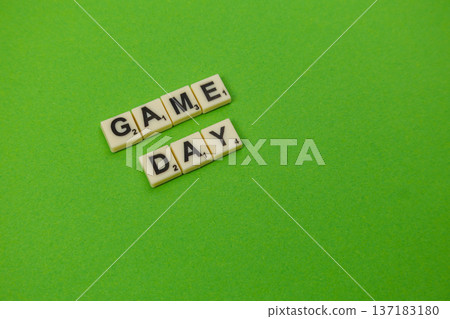 Celebrating National Scrabble Day with game day letters on green surface Celebrating National Scrabble Day with game day letters on green surface 137183180