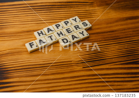 Celebrate National Scrabble Day with words on a wooden table 137183235