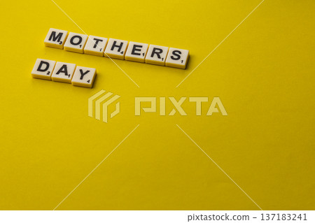 Celebrate National Scrabble Day with words on a yellow background Celebrate National Scrabble Day with words on a yellow background 137183241