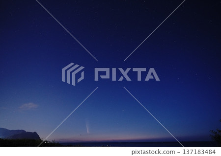 Comet shining in the night sky Comet shining in the night sky 137183484