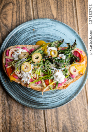 Brunch toast. Spicy meal. Appetizing sandwich with creative vegetable bright toppings. Beetroot sauce food with roasted greens cream olives on bread. Brunch toast. Spicy meal. Appetizing sandwich with creative vegetable bright toppings. Beetroot sauce food with roasted greens cream olives on bread. 137183768