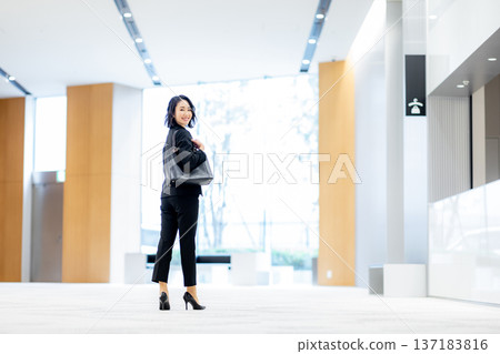 Young business woman in the office 137183816