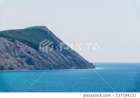 High mountain slopes to the Black Sea coast in Anapa, Russia. Coastline in sunset, beautiful sea scenery. Anapa coast landscape, high cliff High mountain slopes to the Black Sea coast in Anapa, Russia. Coastline in sunset, beautiful sea scenery. Anapa coast landscape, high cliff 137184151
