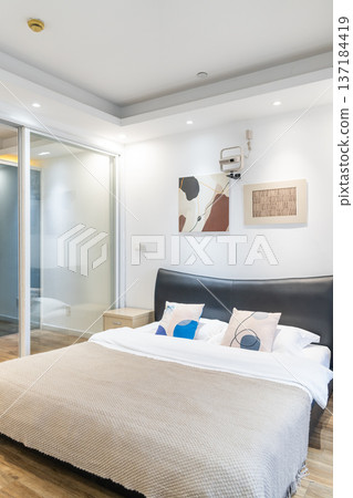 Bedroom and open kitchen space in a modern studio apartment Bedroom and open kitchen space in a modern studio apartment 137184419
