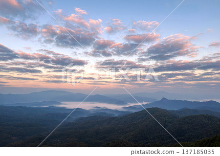 Spectacular sunrise over a mountain range with a sea of mist and colorful clouds. 137185035
