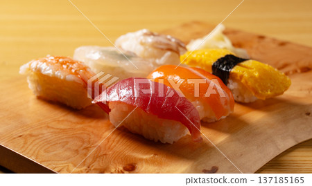 Assorted nigiri sushi served on a wooden board Assorted nigiri sushi served on a wooden board 137185165
