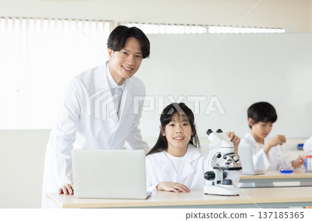 Elementary school students and teachers studying science 137185365