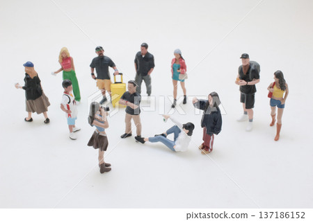 Miniature Figures Spread Out Engaging In Varied Poses Miniature Figures Spread Out Engaging In Varied Poses 137186152