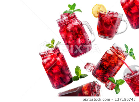 Various hibiscus iced tea drinks in clear jars with herbs isolated on white, concept of refreshing summer beverages 137186745