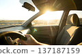 AI-generated image of the interior of a car showing intense sunlight and intense heat streaming into the driver's seat 137187159