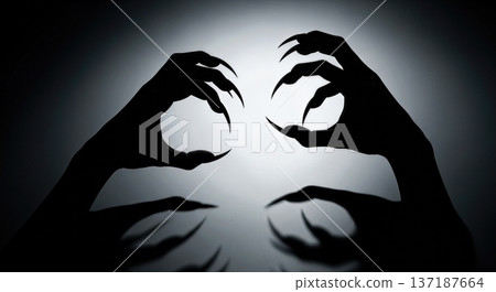 Silhouette of scary monster hands with sharp claws and long fingers isolated on white background representing halloween horror and nightmare fear Silhouette of scary monster hands with sharp claws and long fingers isolated on white background representing halloween horror and nightmare fear 137187664