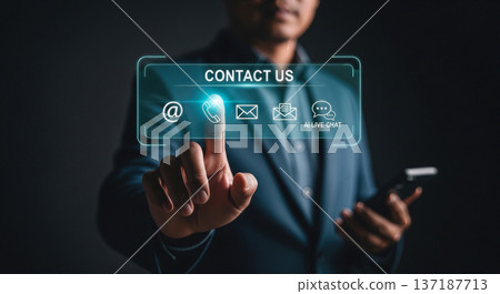 Businessman touching virtual contact us interface with email phone and chat icons on dark background for customer support service concept Businessman touching virtual contact us interface with email phone and chat icons on dark background for customer support service concept 137187713