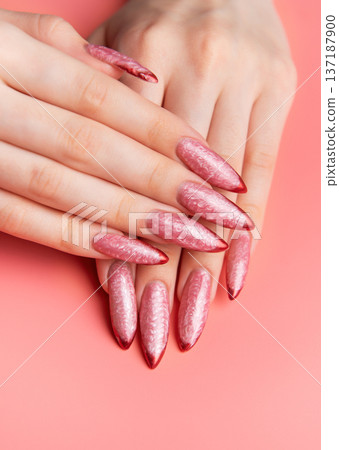 Woman showing stiletto pink and red ombre nails Woman showing stiletto pink and red ombre nails 137187900
