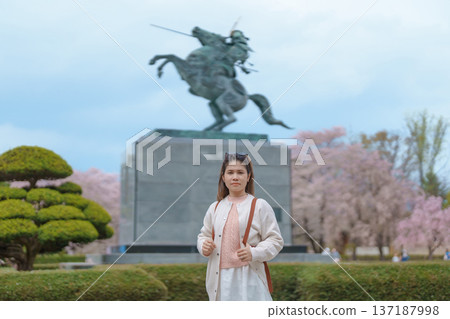 Woman tourist sightseeing Kajo Park Yamagata Castle Ruins with Sakura Cherry Blossom in Spring, happy traveler travel in Yamagata prefecture, Tohoku, Japan. famous Landmark for Travel and Vacation 137187998