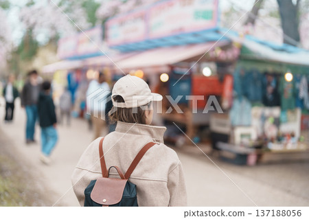 Woman tourist sightseeing Hirosaki Castle park with Sakura Cherry Blossom in Spring, traveler travel in Hirosaki city, Aomori, Tohoku, Japan. Landmark famous in Japan. Travel and Vacation destination 137188056