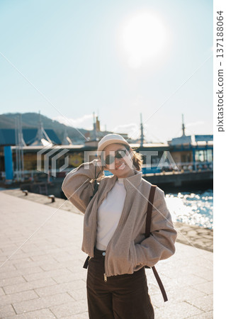 Woman tourist Visiting in Hakodate, happy Traveler sightseeing Kanemori Red Brick Warehouse in spring season. landmark and popular for attractions in Hokkaido, Japan. Travel and Vacation concept Woman tourist Visiting in Hakodate, happy Traveler sightseeing Kanemori Red Brick Warehouse in spring season. landmark and popular for attractions in Hokkaido, Japan. Travel and Vacation concept 137188064