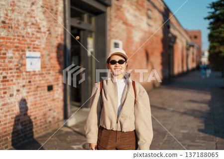 Woman tourist Visiting in Hakodate, happy Traveler sightseeing Kanemori Red Brick Warehouse in spring season. landmark and popular for attractions in Hokkaido, Japan. Travel and Vacation concept 137188065