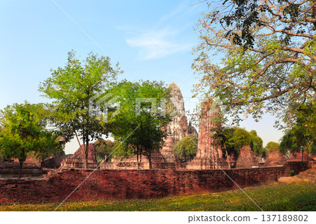 Wat Mahathat, Ayutthaya Historical Park, Thailand, Southeast Asia. Picturesque scene with old thai buddhist temple, stupa ruin, Ayutthaya, old capital of Siam kingdom. Topic of vacation, travel, trip Wat Mahathat, Ayutthaya Historical Park, Thailand, Southeast Asia. Picturesque scene with old thai buddhist temple, stupa ruin, Ayutthaya, old capital of Siam kingdom. Topic of vacation, travel, trip 137189802