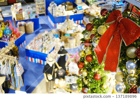 Aerial view of a vibrant tropical shopping mall interior adorned with festive Christmas decorations, showcasing colorful merchandise and a lively atmosphere for holiday shopping 137189896