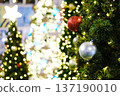 Christmas tree adorned with colorful ornaments and twinkling lights, creating a festive atmosphere for holiday celebrations and New Year greetings with copy space for text 137190010