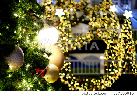 Christmas tree adorned with sparkling ornaments and bright lights, surrounded by festive decorations, creating a warm holiday atmosphere with copy space for text Christmas tree adorned with sparkling ornaments and bright lights, surrounded by festive decorations, creating a warm holiday atmosphere with copy space for text 137190019