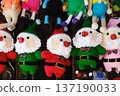 Handmade knitted toys featuring colorful Santa Claus figures in festive attire, perfect for Christmas and New Year celebrations, showcasing craftsmanship and holiday spirit 137190033