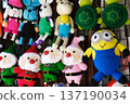 Handmade knitted toys featuring festive characters including Santa Claus, bunnies, and turtles, perfect for Christmas and New Year celebrations, showcasing vibrant colors and intricate designs 137190034