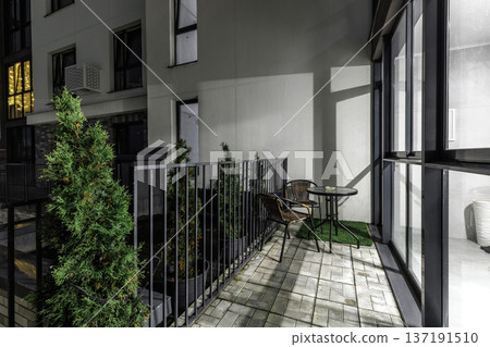 Modern Apartment Balcony with Night Lighting and Outdoor Furniture Modern Apartment Balcony with Night Lighting and Outdoor Furniture 137191510