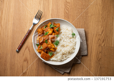 Chicken tikka masala curry with rice on wooden background Chicken tikka masala curry with rice on wooden background 137191753