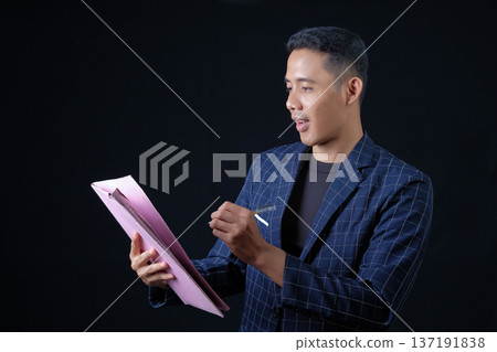 Portrait of handsome elegant man in black suit on black background. Studio mode portrait 137191838