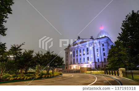 Scenic night view of the illuminated classical facade and dome of the Oklahoma State Capitol building surrounded by dense fog in Oklahoma City. Scenic night view of the illuminated classical facade and dome of the Oklahoma State Capitol building surrounded by dense fog in Oklahoma City. 137193318