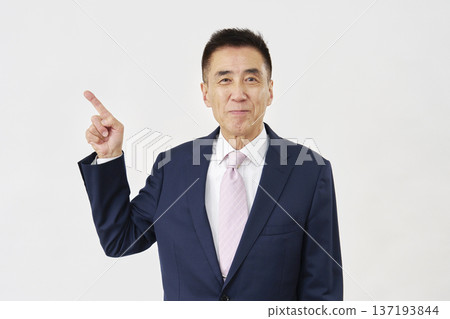 Businessman pointing to the left on white background 137193844