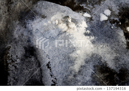 Abstract black and grey watercolour paint and ink swirling on white paper background to look like clouds and monochrome wash Abstract black and grey watercolour paint and ink swirling on white paper background to look like clouds and monochrome wash 137194316