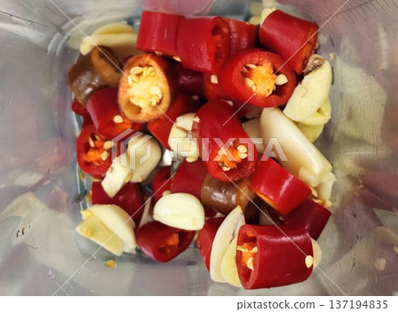 Preparation of Spicy Chili Paste with Fresh Red Peppers and Garlic Cloves Preparation of Spicy Chili Paste with Fresh Red Peppers and Garlic Cloves 137194835